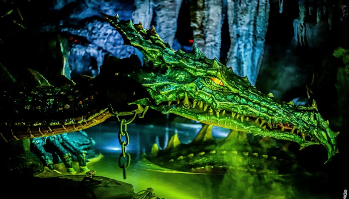 La Tanière du Dragon animatronic dragon in Disneyland Paris cave setting.
