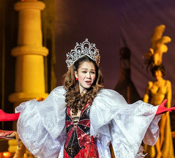 Performer in elaborate costume at Golden Dome Cabaret, Bangkok stage show.