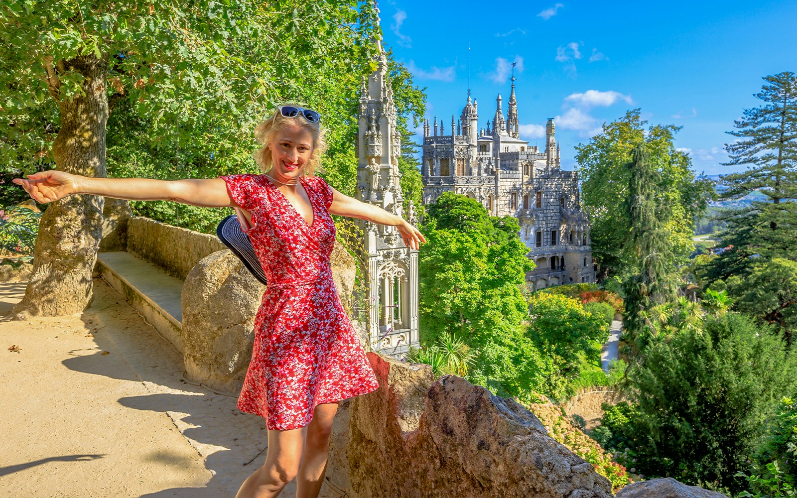 Visitor exploring Quinta da Regaleira's intricate architecture in Sintra, Portugal.