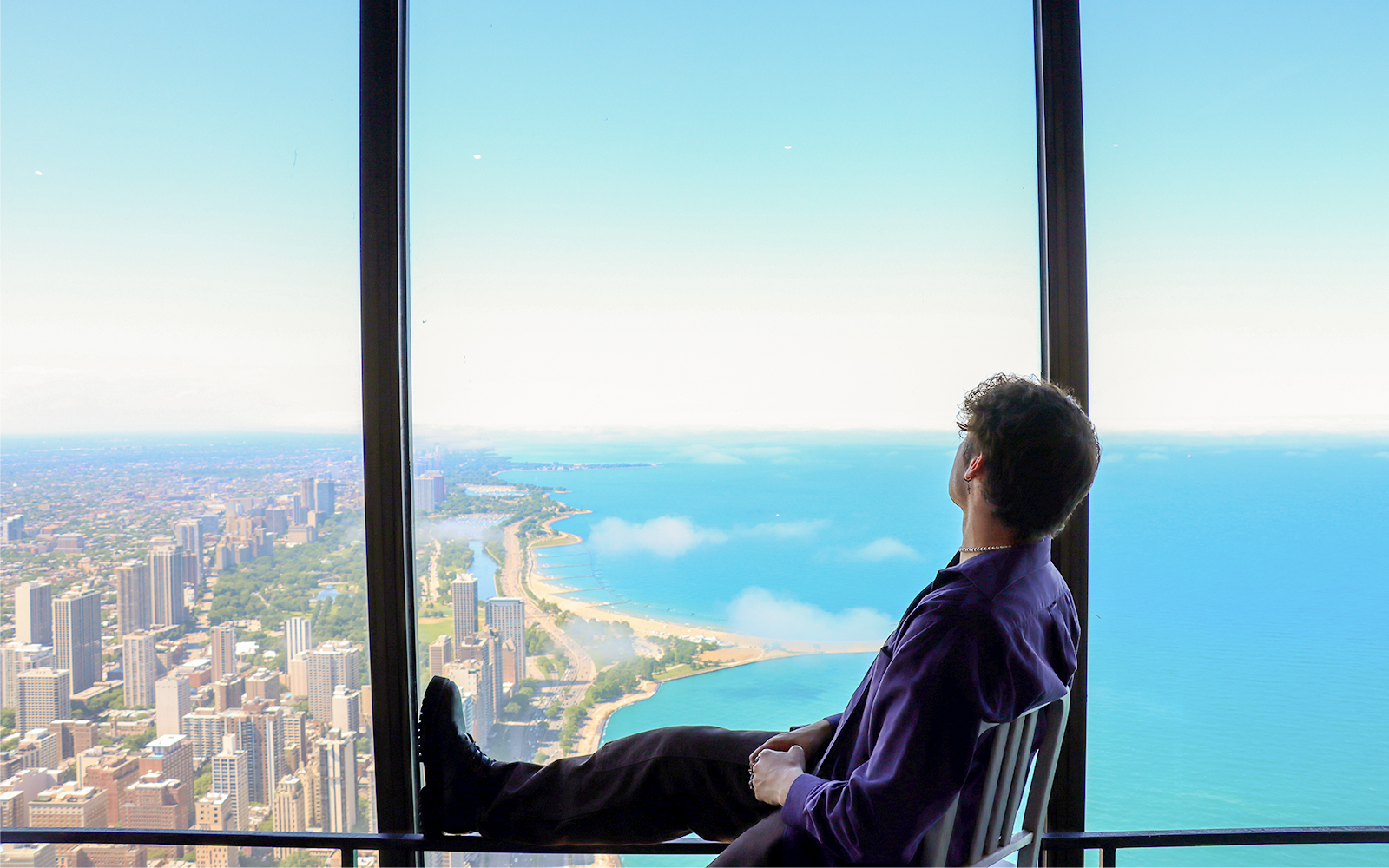 A person sitting on a chair and enjoying the thrilling skyline views of Chicago