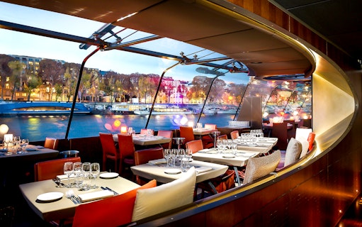 Bateaux Parisiens dining area with Seine River view, Paris New Year’s Eve 2025.