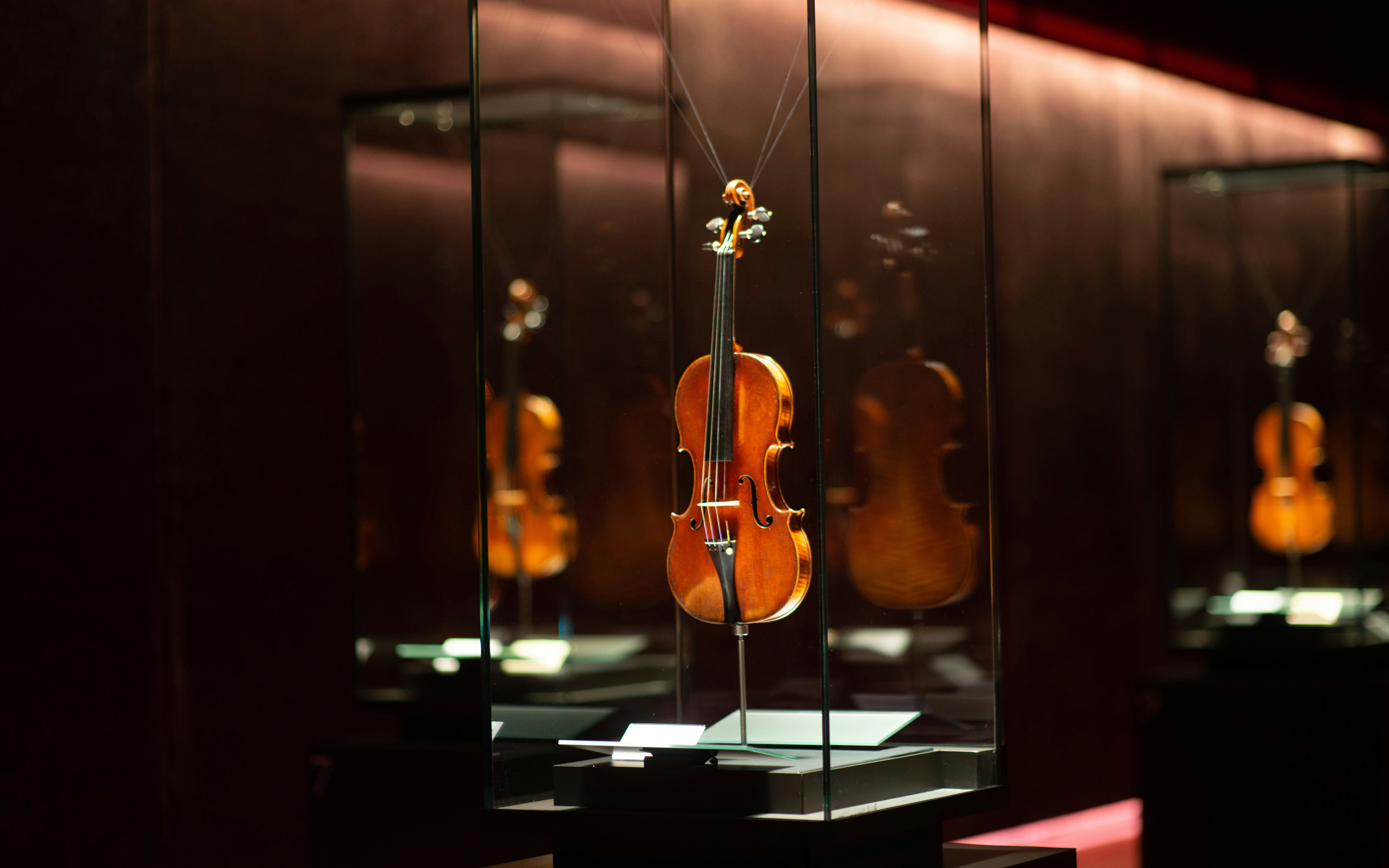 Violin displayed in glass case at violin museum, Cremona, Italy.