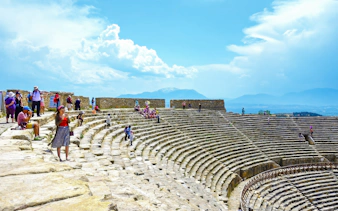 Visitors exploring the ancient theatre of Hierapolis in Pamukkale, Turkey.
