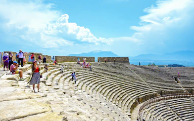 Visitors exploring the ancient theatre of Hierapolis in Pamukkale, Turkey.