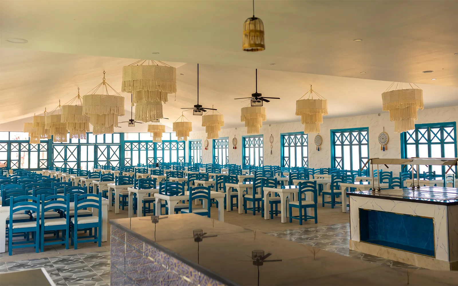 Dining area with blue chairs and chandeliers on Bianca Island Utopia cruise, Hurghada.