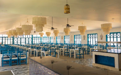 Dining area with blue chairs and chandeliers on Bianca Island Utopia cruise, Hurghada.