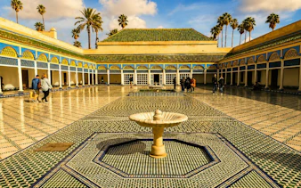 Bahia Palace courtyard with fountain and mosaic tiles, Marrakech tour.