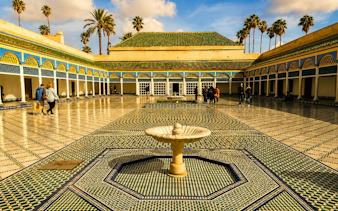 Bahia Palace courtyard with fountain and mosaic tiles, Marrakech tour.
