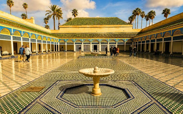 Bahia Palace courtyard with fountain and mosaic tiles, Marrakech tour.