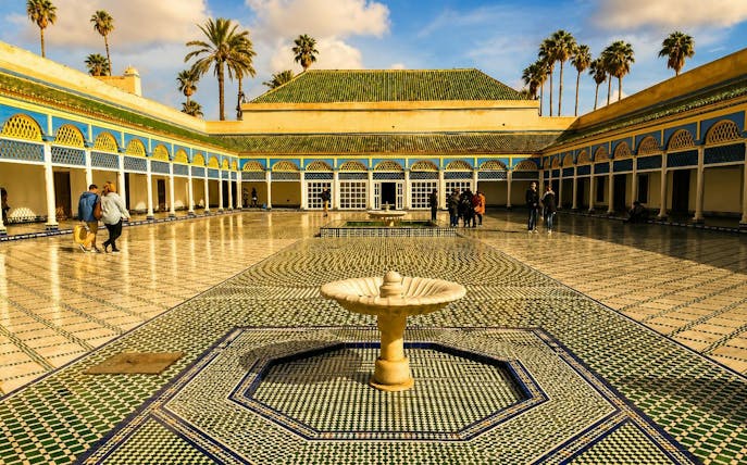 Bahia Palace courtyard with fountain and mosaic tiles, Marrakech tour.