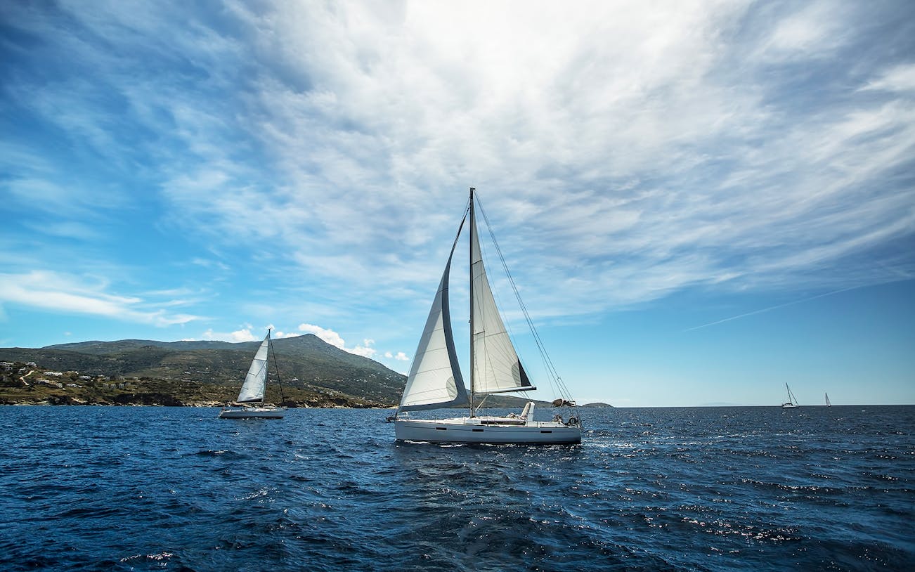 Sailboats on the Aegean Sea during a Santorini sightseeing tour.
