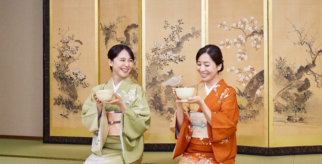 Two women in kimonos participating in a traditional tea ceremony in Tokyo Maikoya.