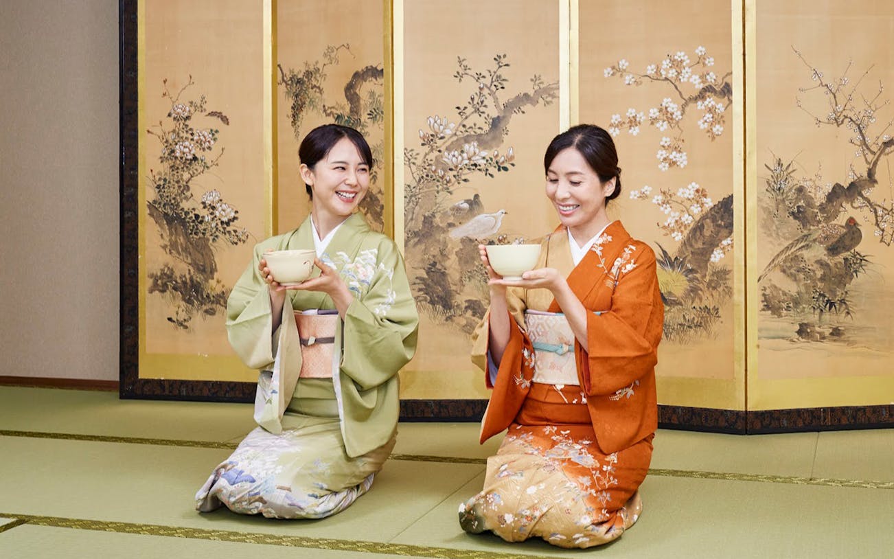 Two women in kimonos participating in a traditional tea ceremony in Tokyo Maikoya.