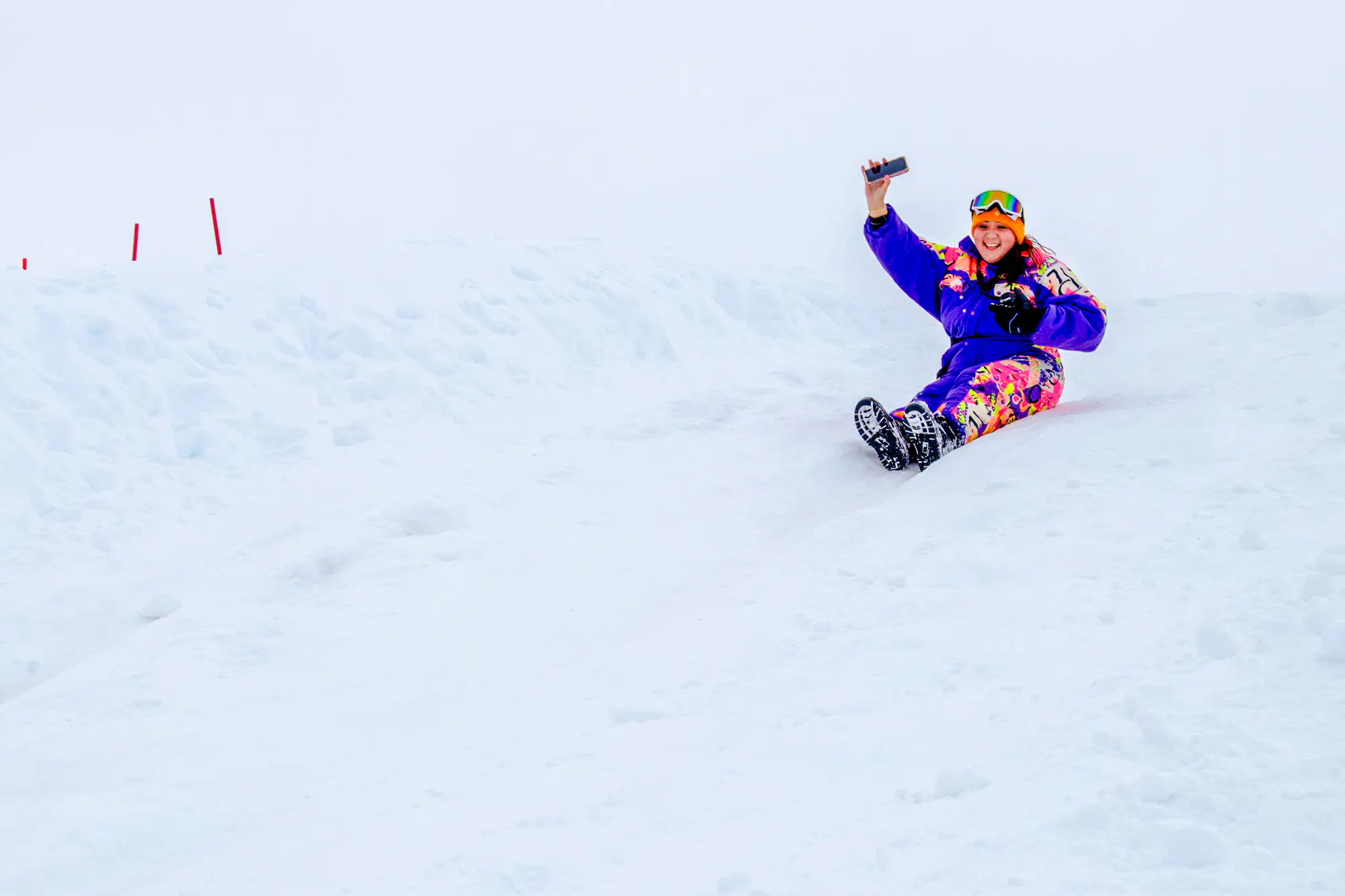 Person sledding on snowy slope at Valle Nevado, Santiago.