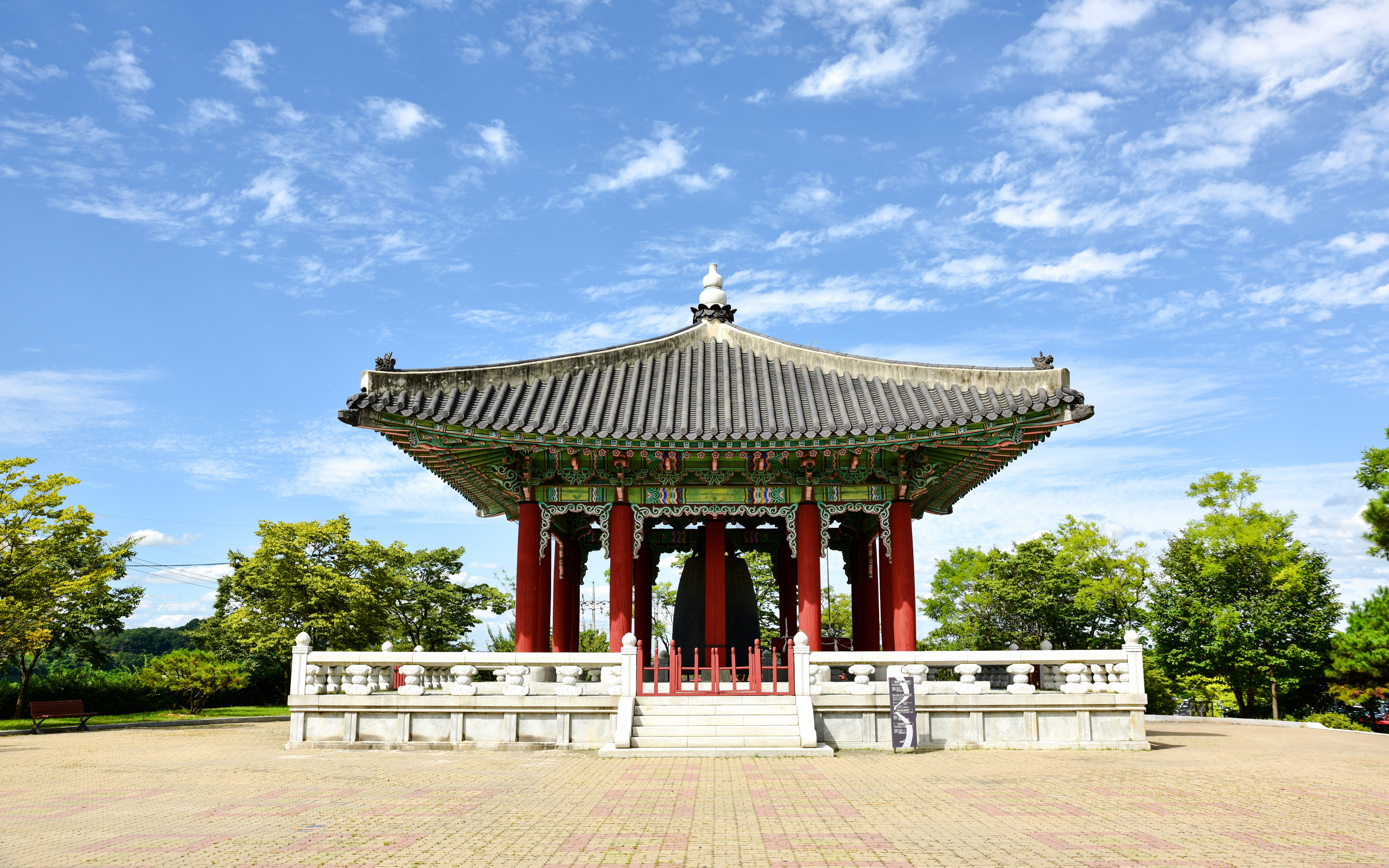 Traditional pavilion at Imjingak, Paju, South Korea, surrounded by trees and clear sky.
