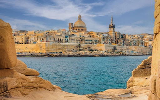 Valletta skyline with dome and spire viewed from the sea, Malta.