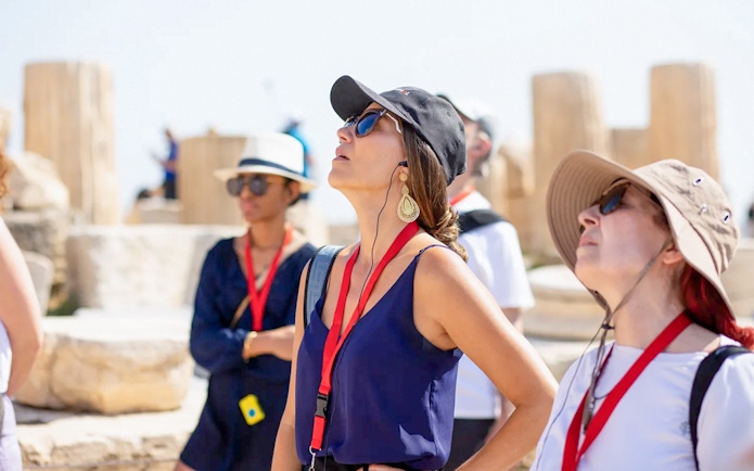 Guests using audio guides during Acropolis Parthenon tour in Athens.