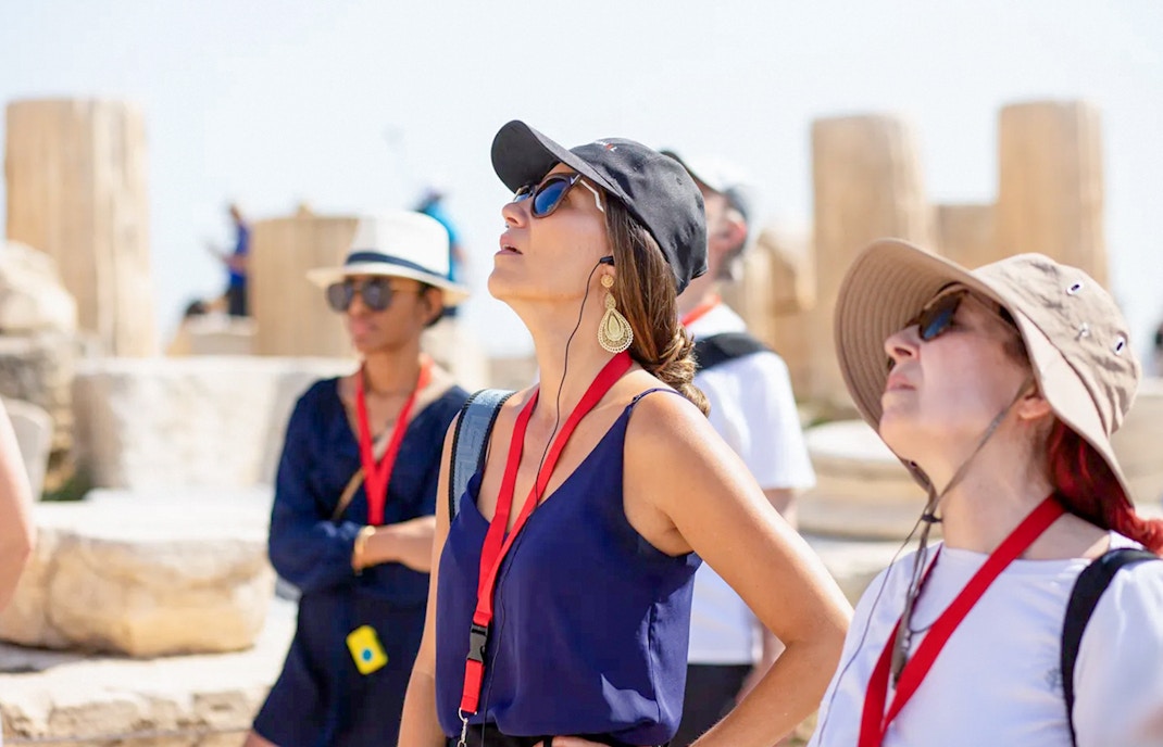 Guests using audio guides during Acropolis Parthenon tour in Athens.