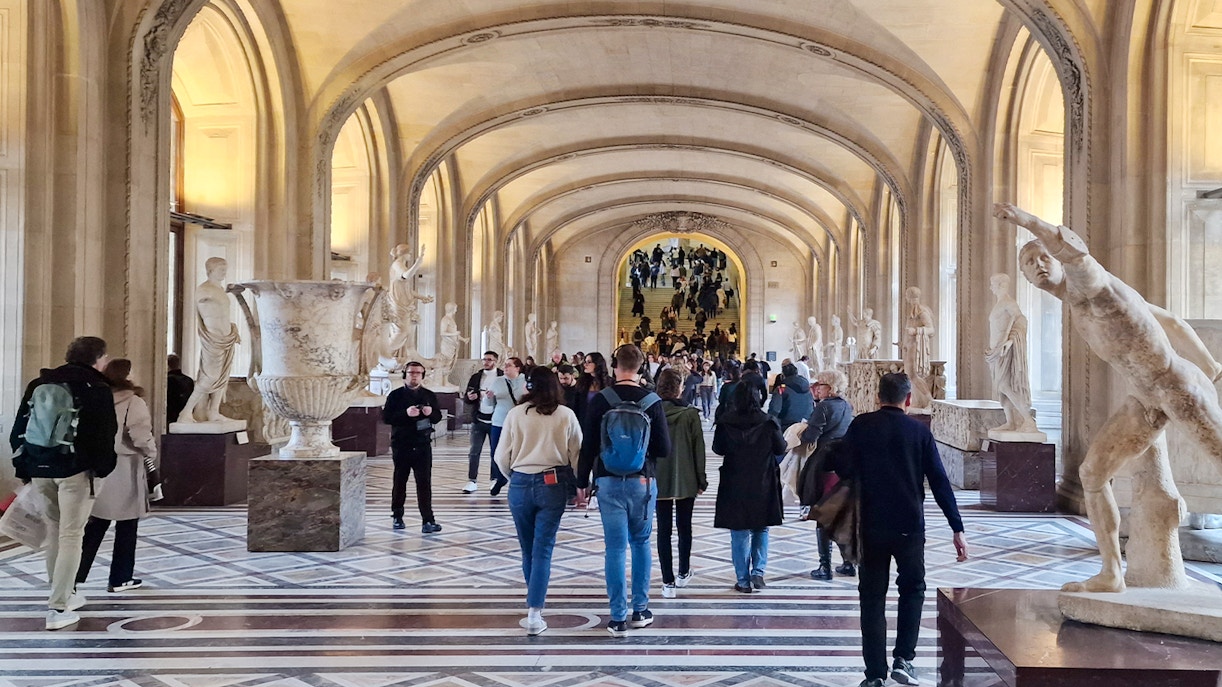 Tourists exploring art at the Louvre Museum, Paris, France