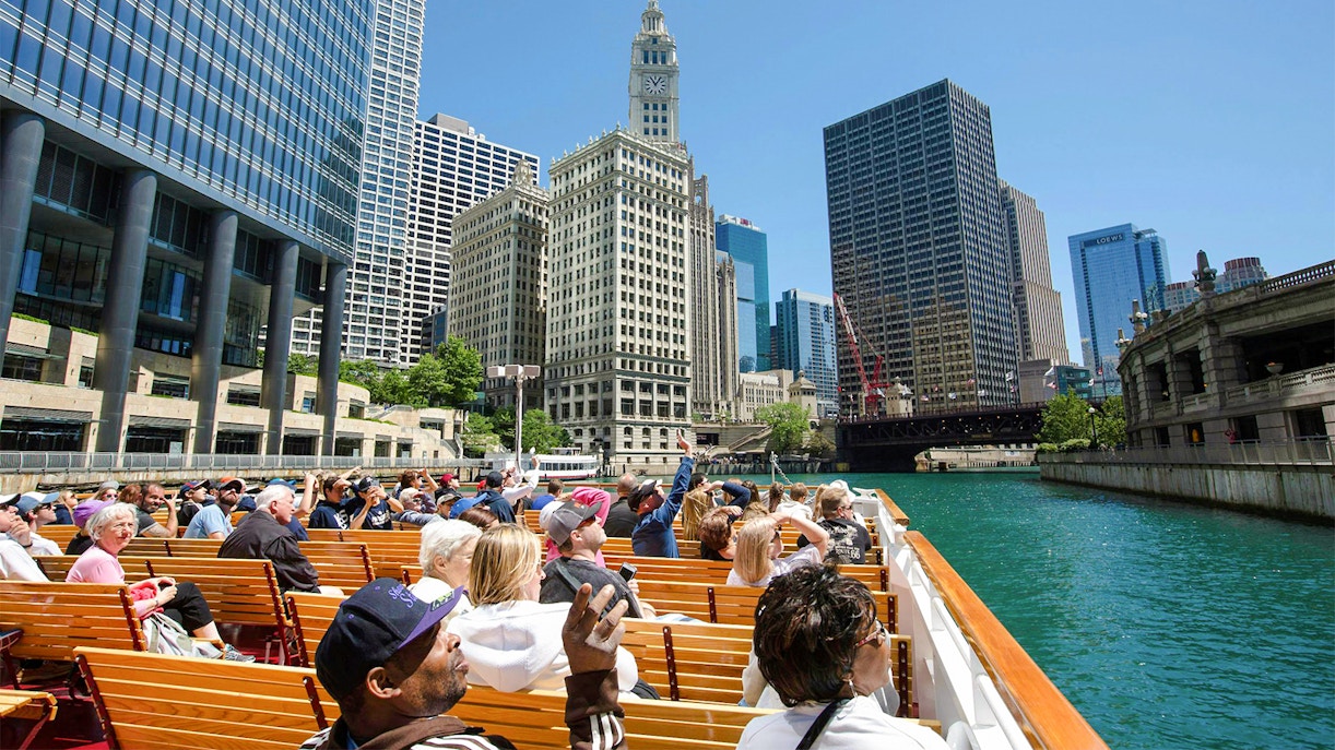 Visitors on a 90-minute Chicago River Architecture Cruise viewing iconic skyscrapers.