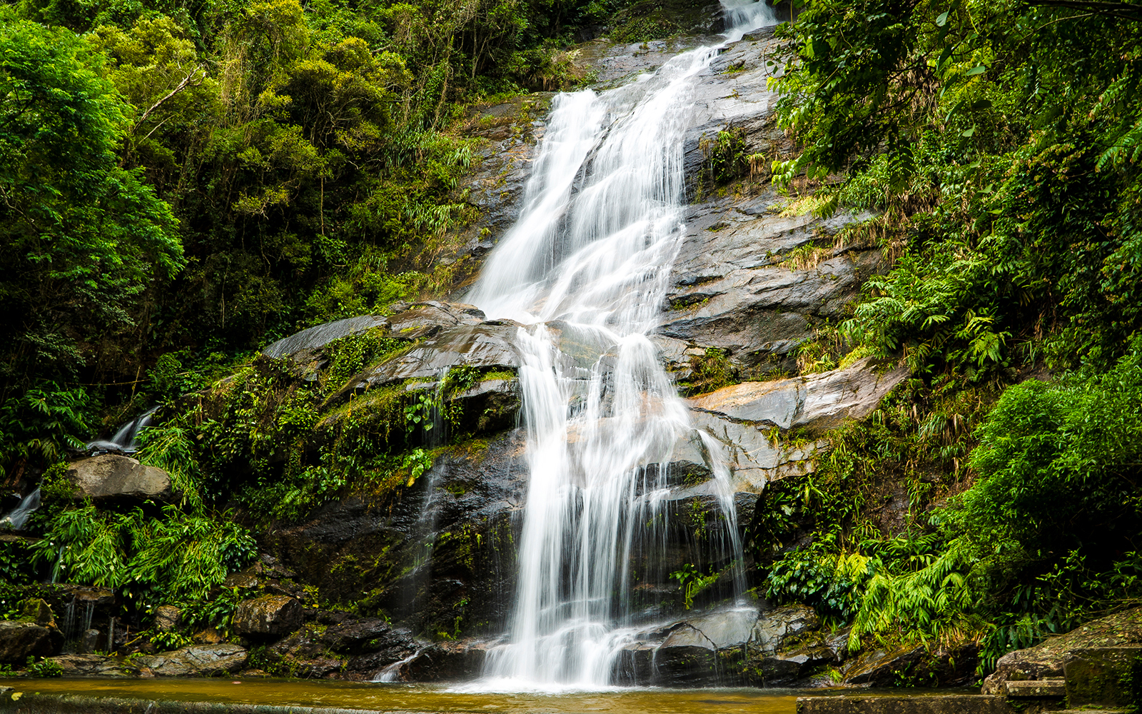 Waterfall cascading over rocks in Tijuca Forest, Rio de Janeiro, Brazil.