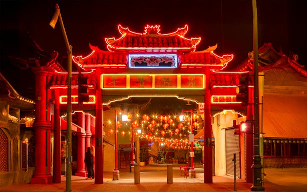 Chinatown gate illuminated with holiday lights, Los Angeles Big Bus tour.
