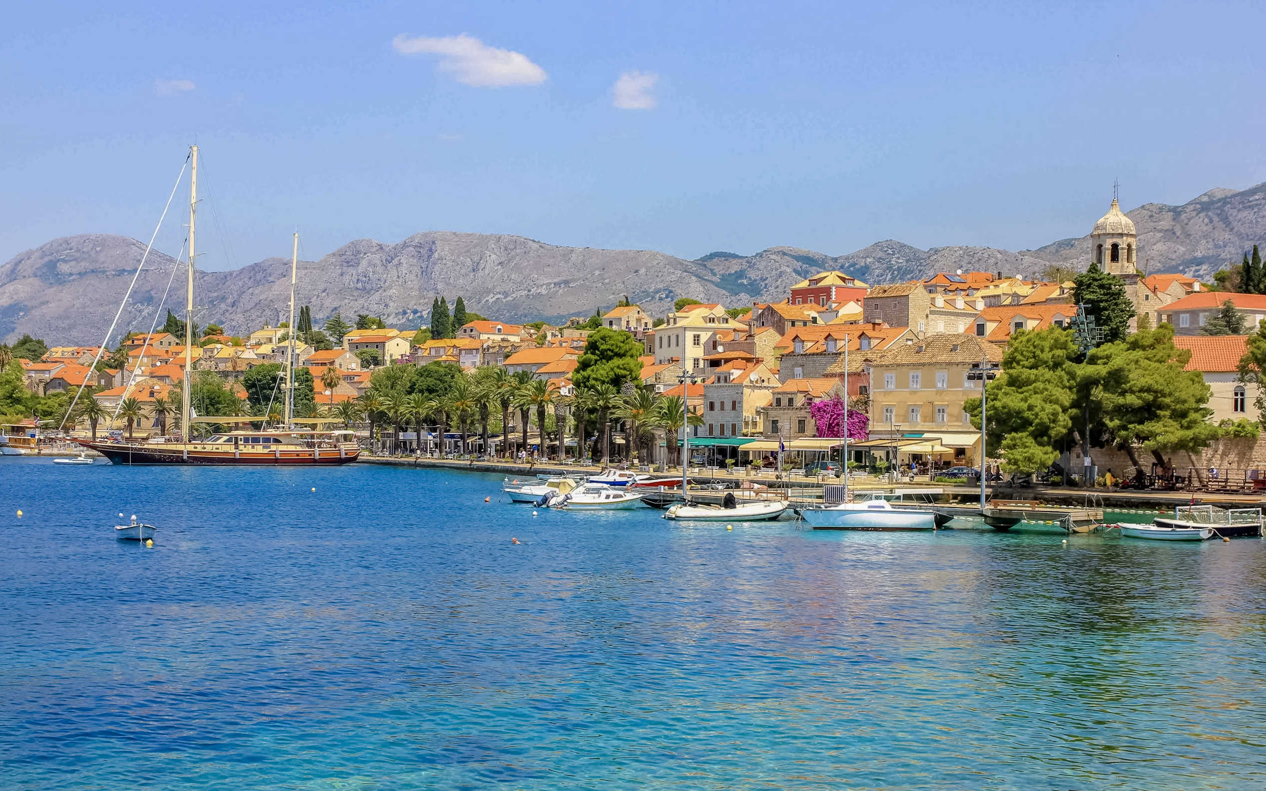 Coastal view of Cavtat, Croatia with boats and historic buildings.
