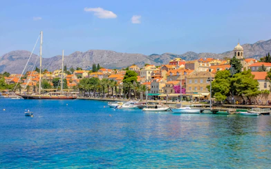 Coastal view of Cavtat, Croatia with boats and historic buildings.