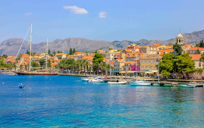 Coastal view of Cavtat, Croatia with boats and historic buildings.