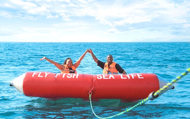 Couple enjoying Fly Fish ride on the ocean.