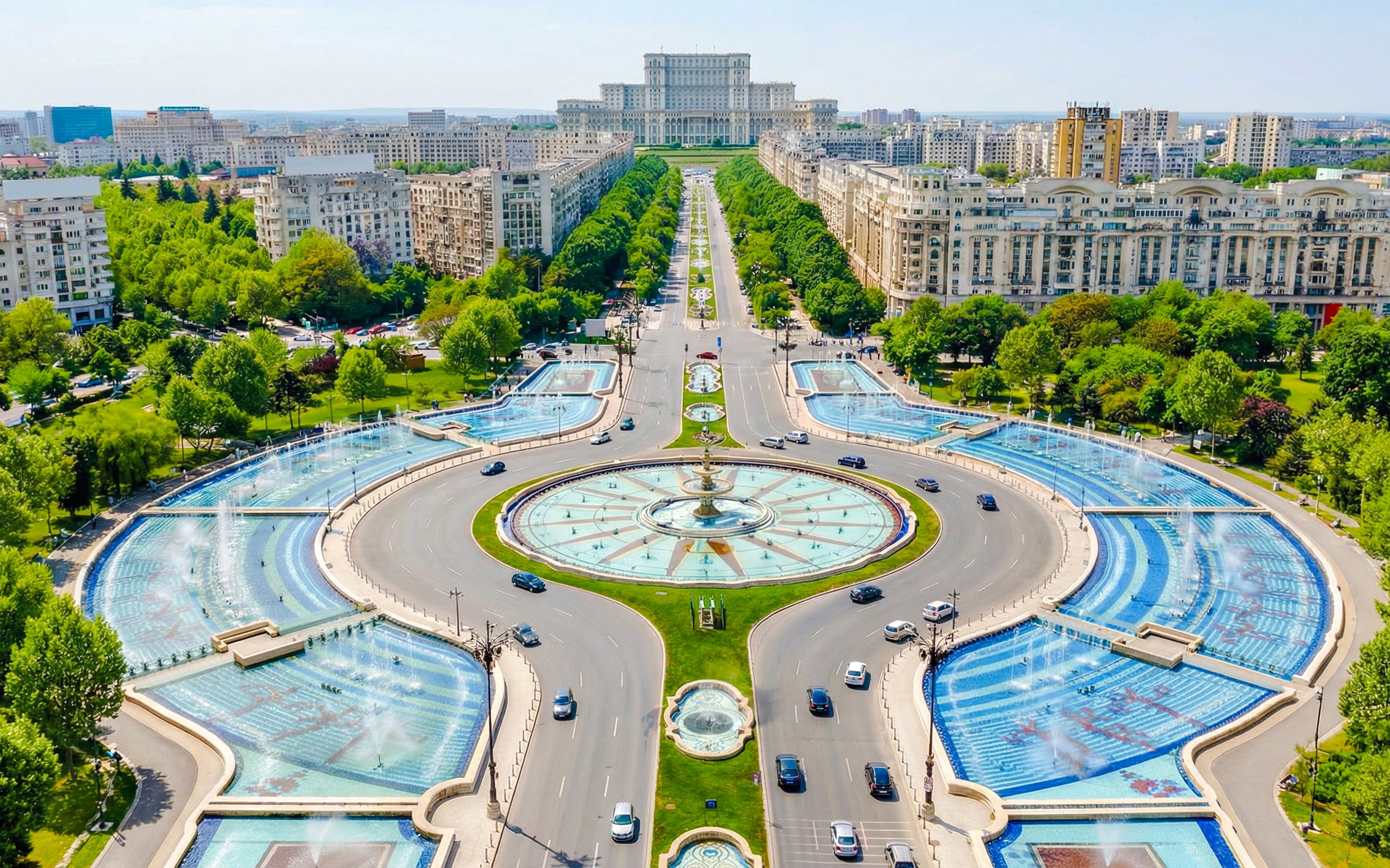 Parliament of Romania with surrounding fountains and boulevard in Bucharest.