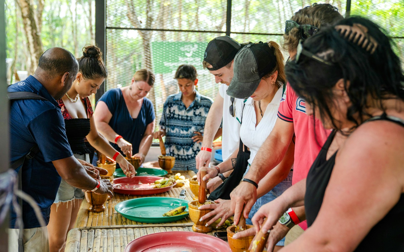 Preparing elephant food at Khaolak Ethical Elephant Sanctuary with visitors.