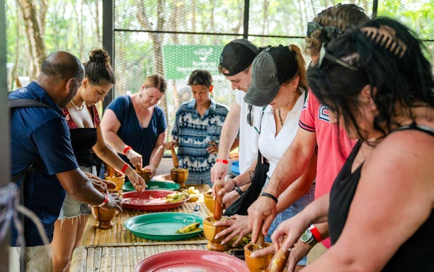 Preparing elephant food at Khaolak Ethical Elephant Sanctuary with visitors.
