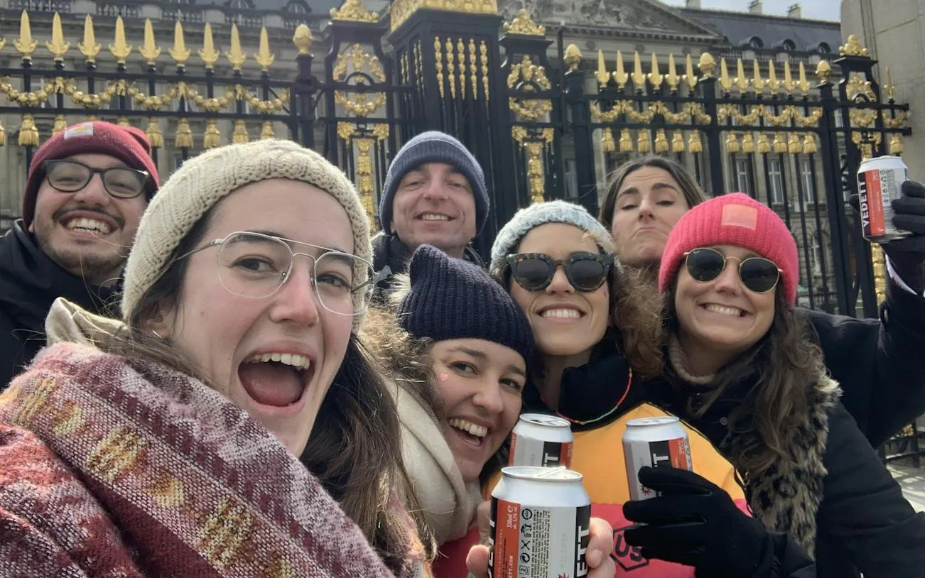 Group enjoying Brussels Dutchman's Gold Treasure Hunt near ornate gate.
