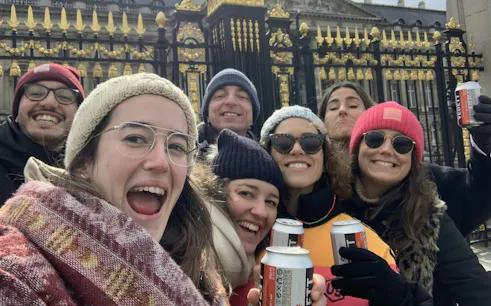 Group enjoying Brussels Dutchman's Gold Treasure Hunt near ornate gate.