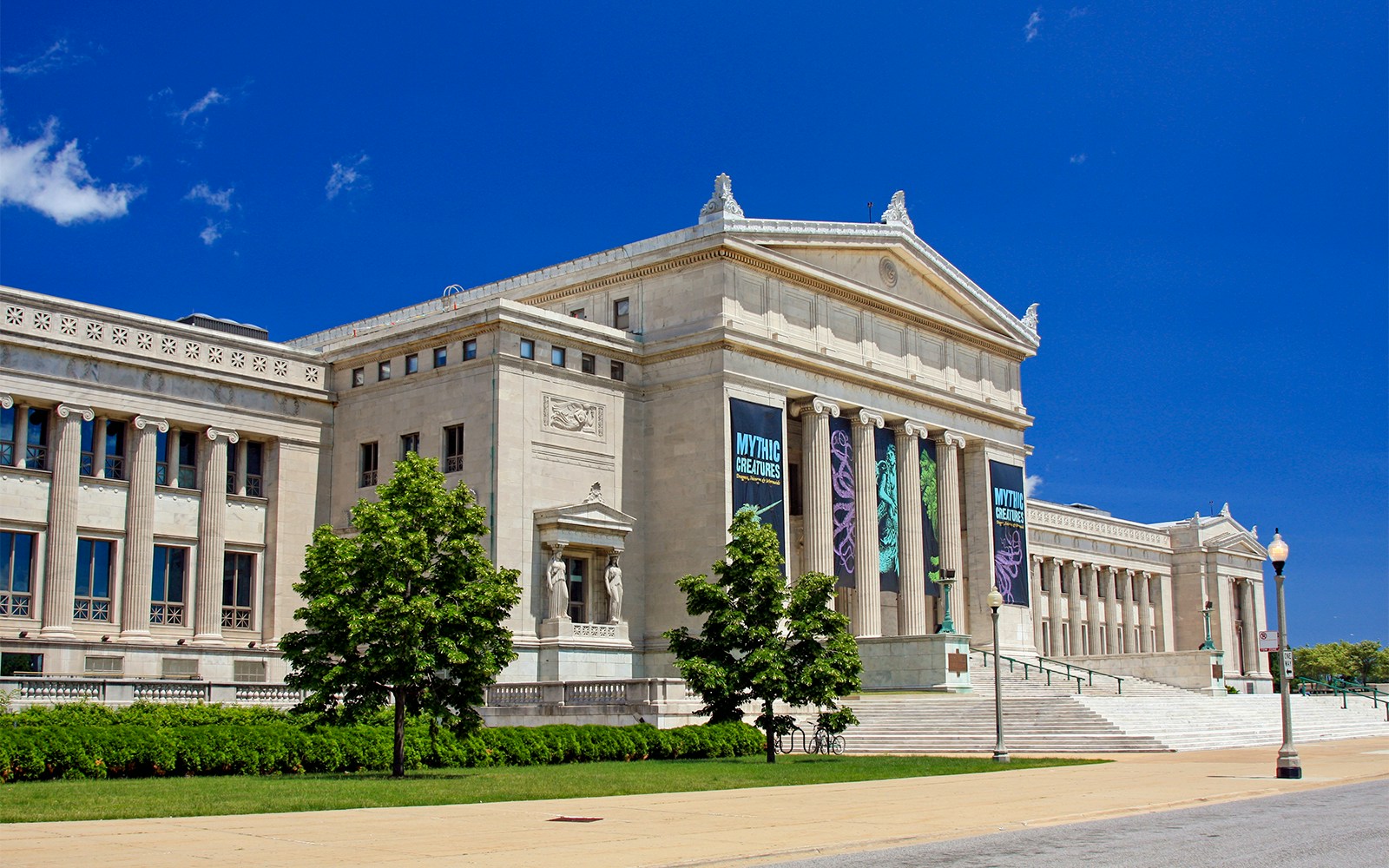 Open-top bus at Museum Campus Chicago with tourists exploring nearby attractions.