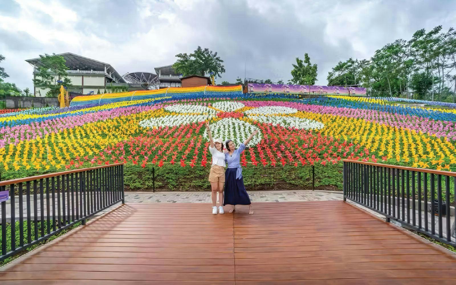Tourists enjoying colorful tulip garden at Dairyland Farm Theme Park.