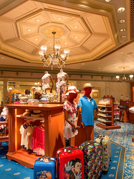 Gift shop interior at Disneyland Hong Kong with Disney-themed merchandise and souvenirs.