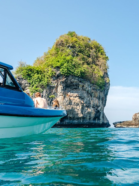 Speedboat "Simba 7" near limestone karsts at Phi Phi Island, Thailand.