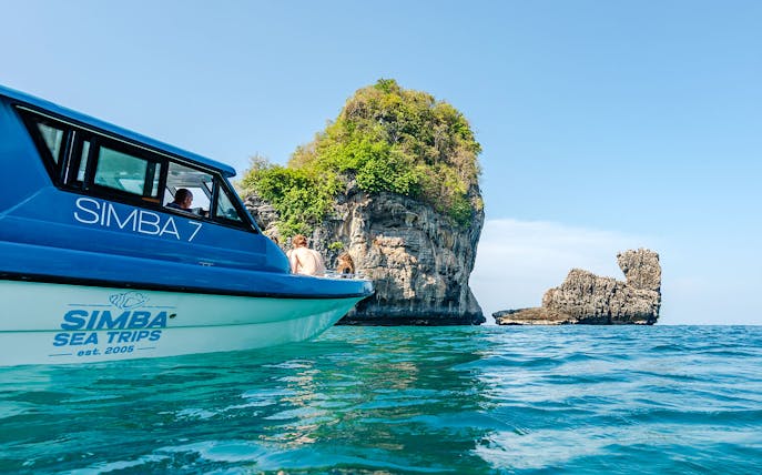 Speedboat "Simba 7" near limestone karsts at Phi Phi Island, Thailand.