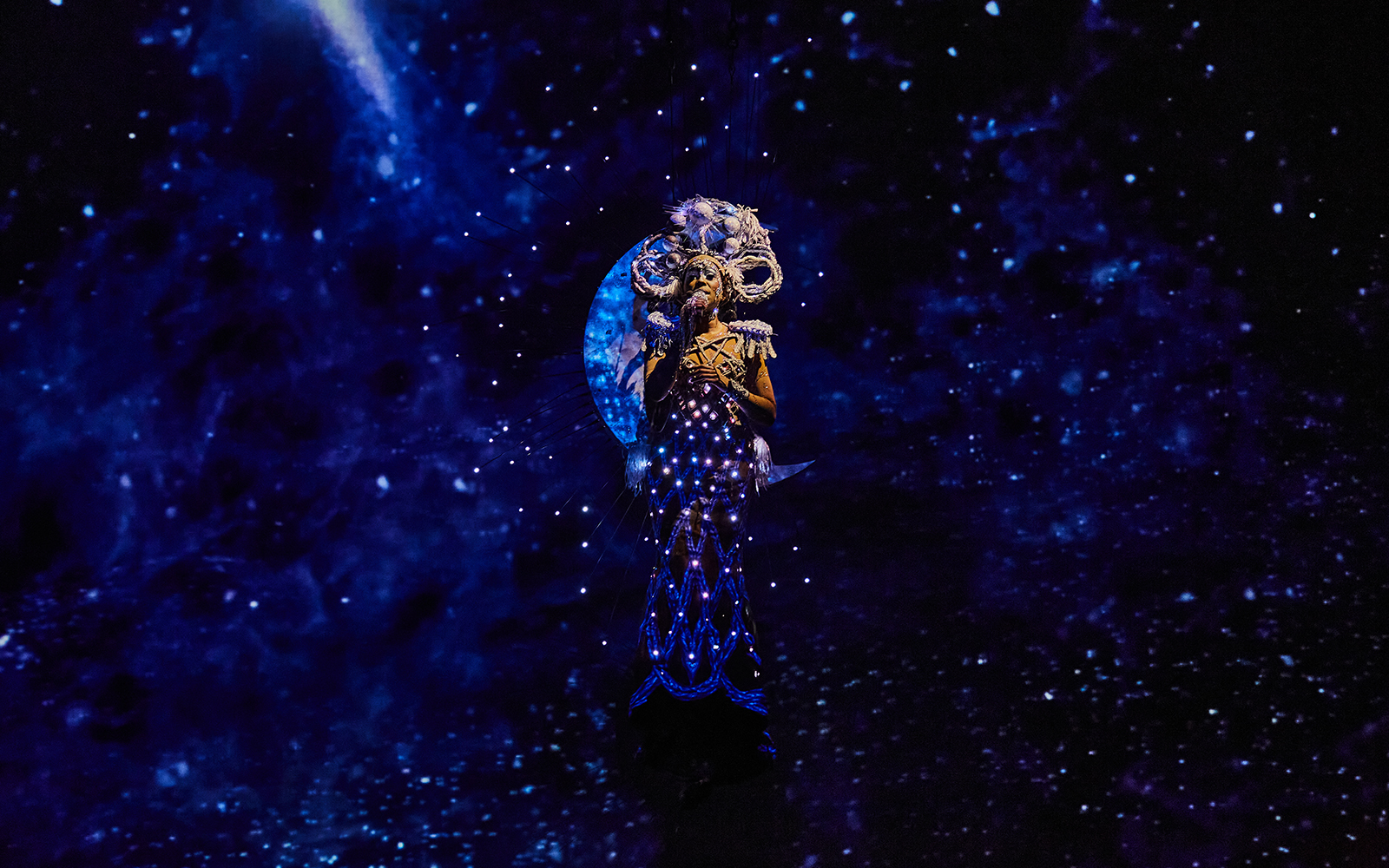 Performer in illuminated costume during Michael Jackson ONE show.