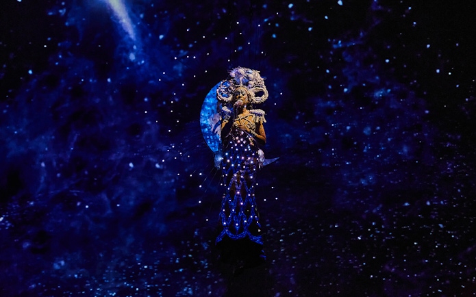 Performer in illuminated costume during Michael Jackson ONE show.