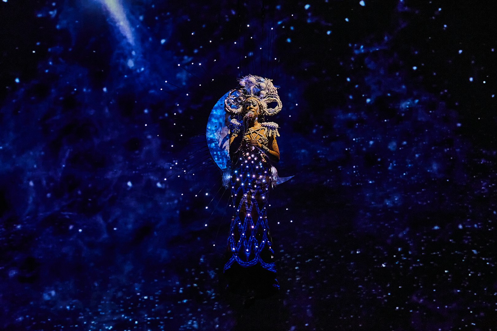 Performer in illuminated costume during Michael Jackson ONE show.