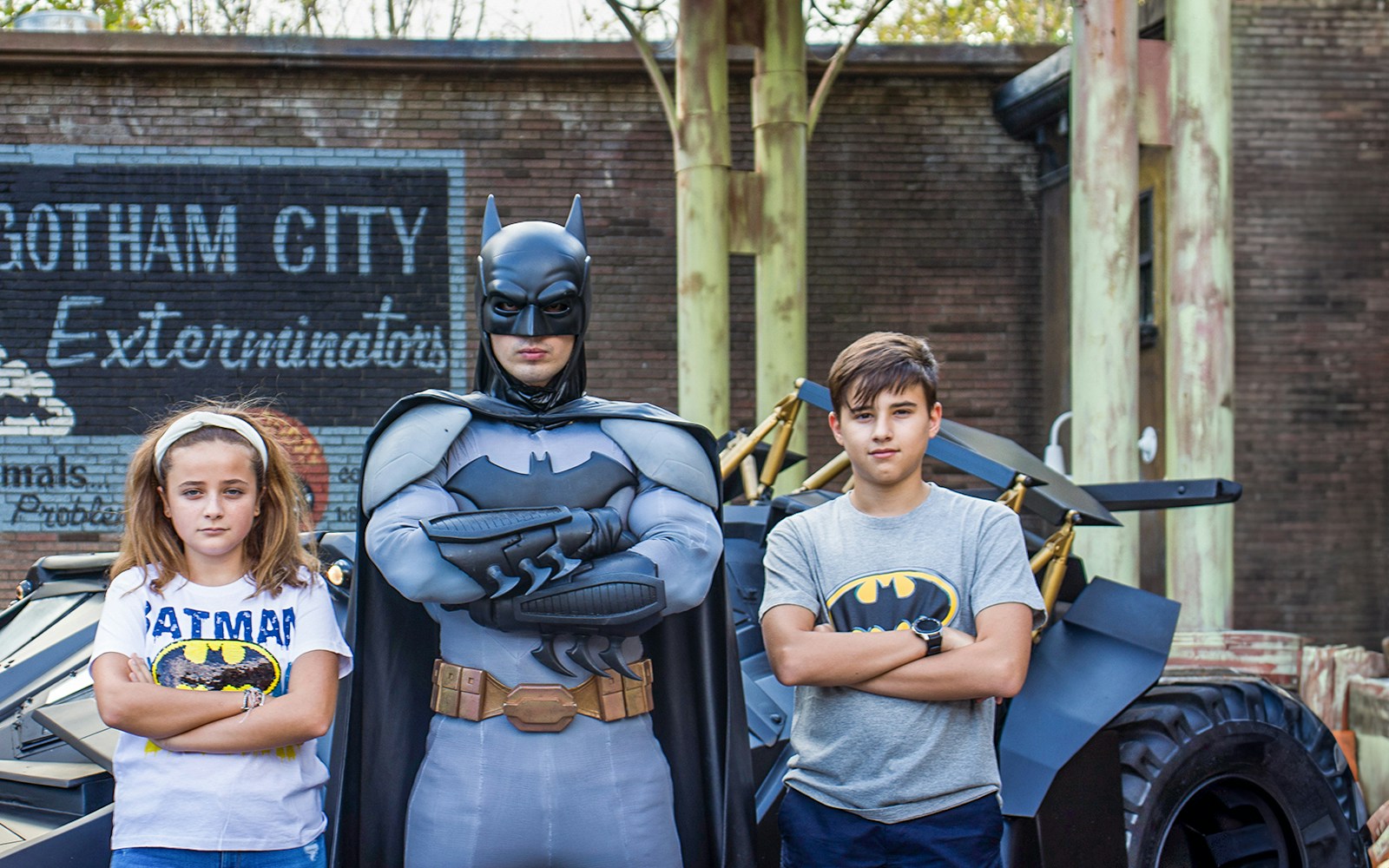 Children posing with Batman at Parque Warner Madrid theme park.