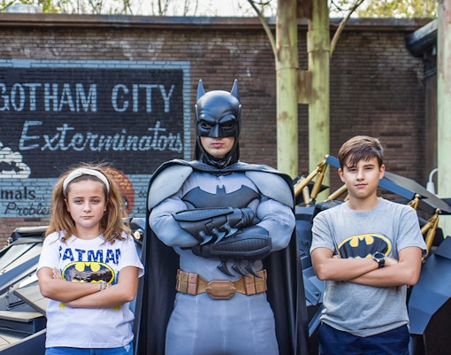 Children posing with Batman at Parque Warner Madrid theme park.