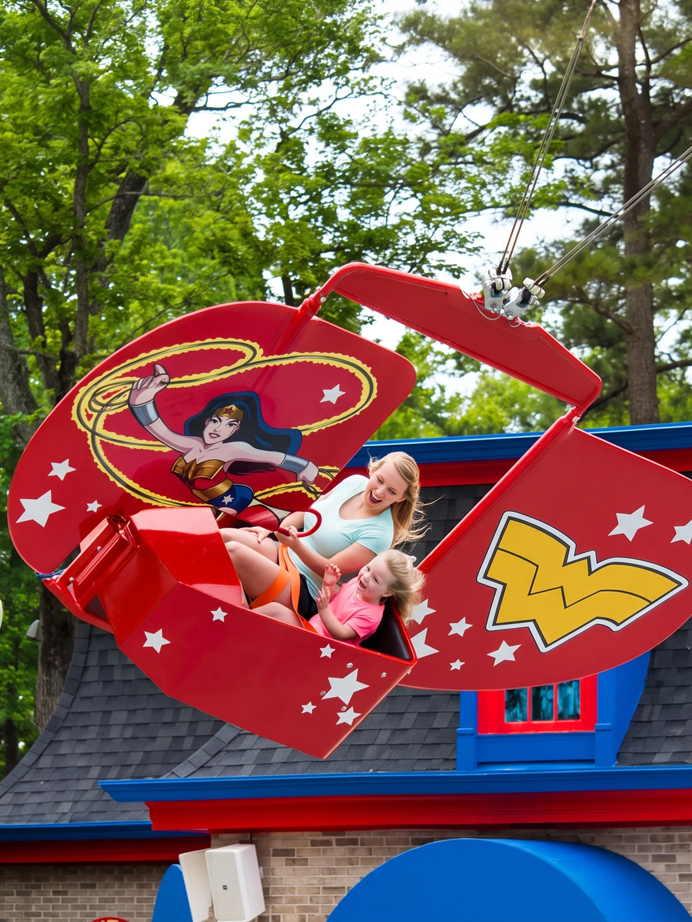 Visitors enjoying the WONDER WOMAN™ Flight School ride at Six Flags Over Georgia.