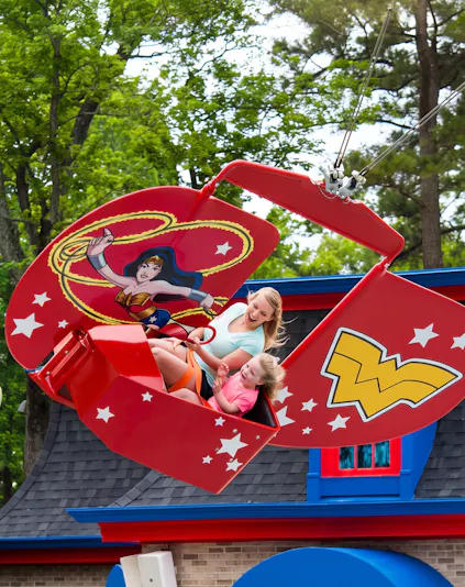 Visitors enjoying the WONDER WOMAN™ Flight School ride at Six Flags Over Georgia.