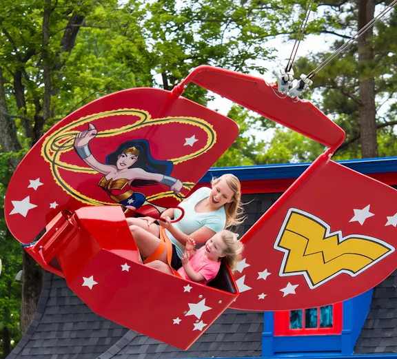Visitors enjoying the WONDER WOMAN™ Flight School ride at Six Flags Over Georgia.