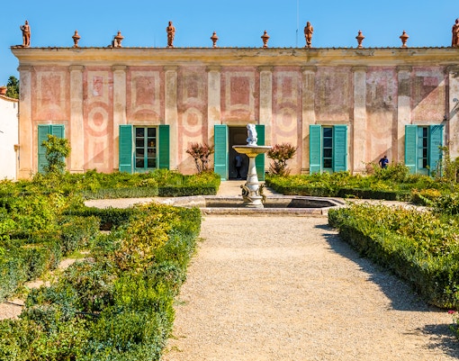 Porcelain museum facade in Bardini Gardens, Florence with statues and greenery.