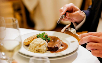 Dining experience at Imperial Gala Concert, Palais Auersperg, Vienna with plated meal.